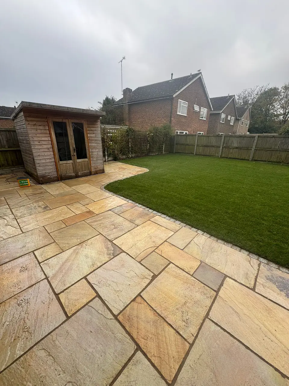 Artificial grass surface in a planted garden