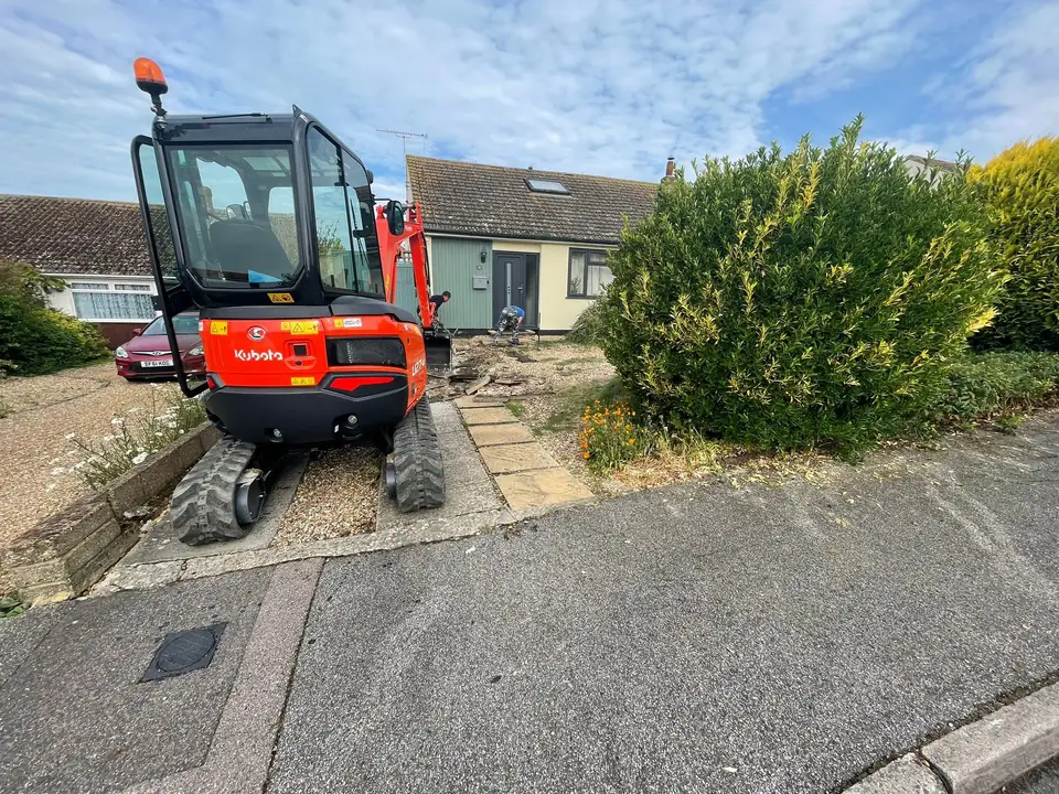 Mini excavator clearing an existing front garden during driveway work