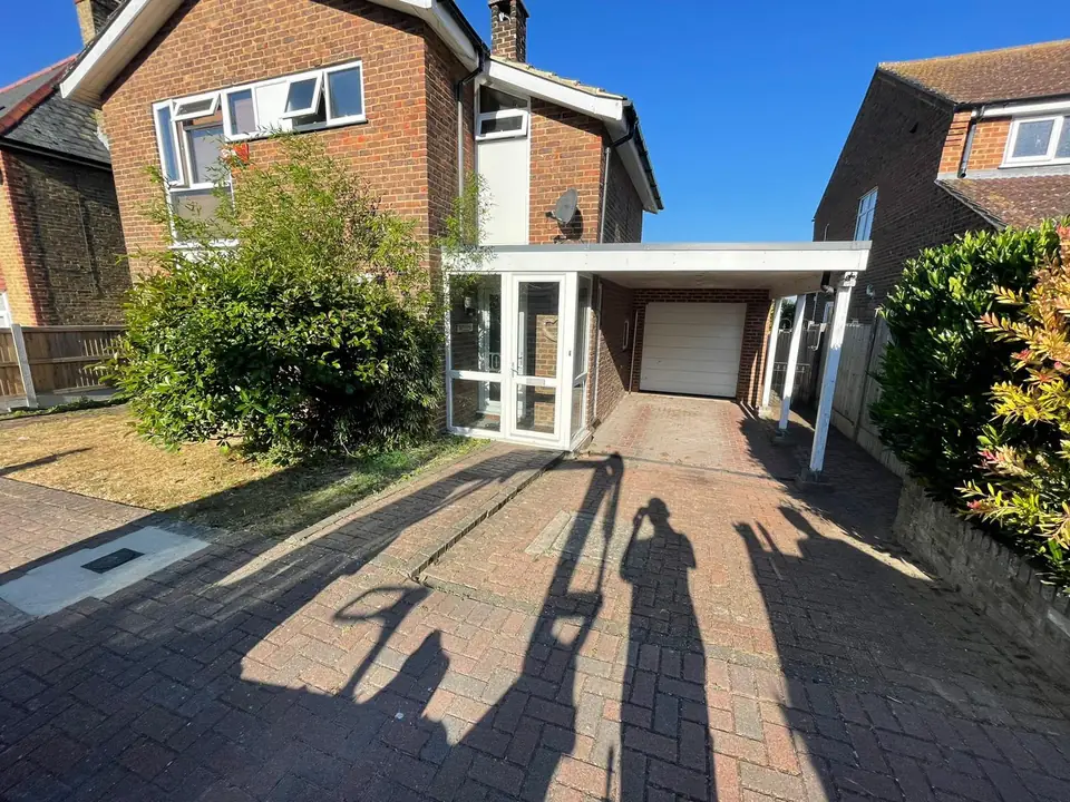 Existing block-paved driveway beneath a covered entrance before resurfacing