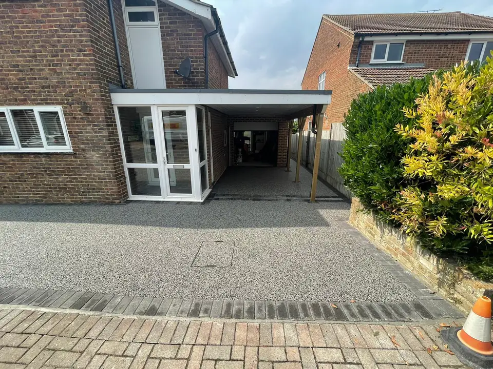 Finished grey resin-bound driveway with a dark contrasting perimeter edge