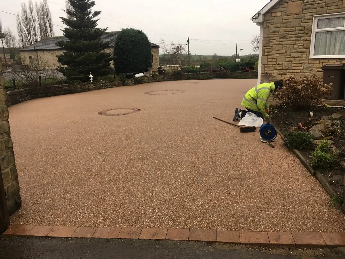 People laying an outdoor surface